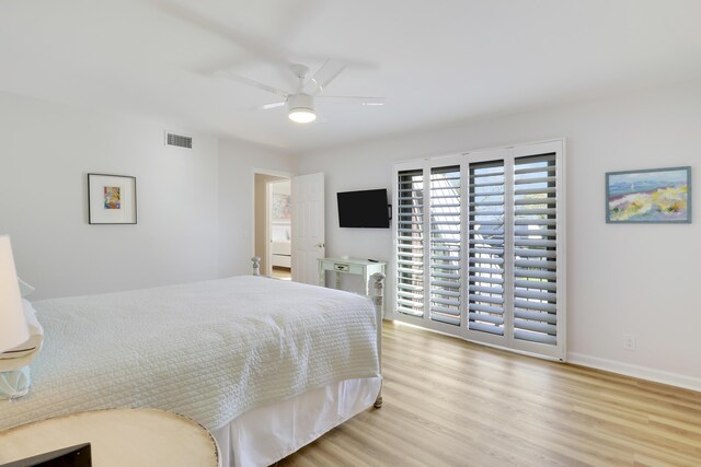 bedroom with visible vents, a ceiling fan, baseboards, and wood finished floors