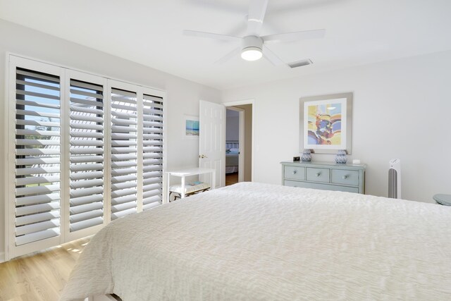 bedroom featuring visible vents, a ceiling fan, and wood finished floors