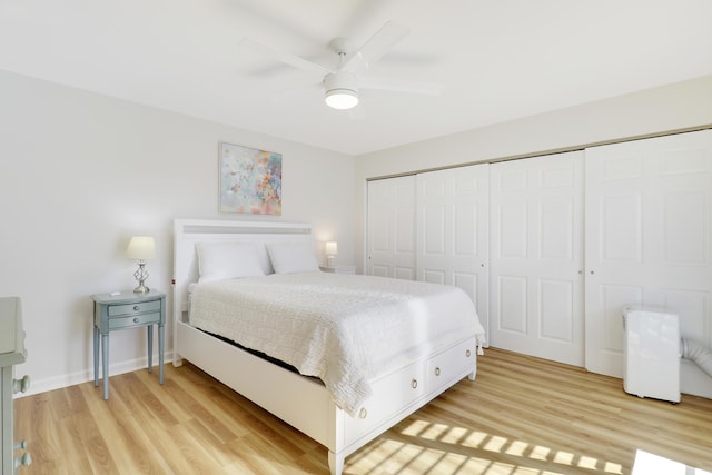 bedroom with baseboards, light wood-style floors, a closet, and ceiling fan