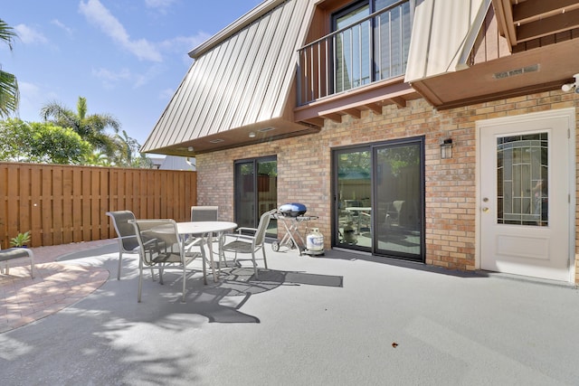 view of patio / terrace featuring outdoor dining space and fence