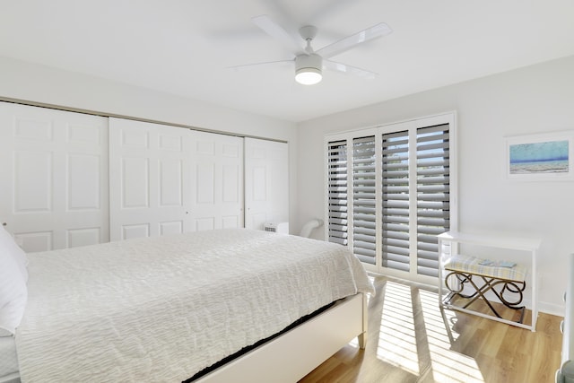 bedroom with a closet, light wood finished floors, baseboards, and ceiling fan