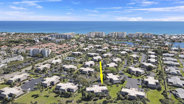 birds eye view of property featuring a city view and a water view