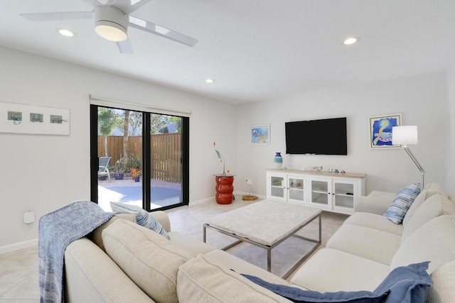 living room with light tile patterned floors, recessed lighting, baseboards, and ceiling fan