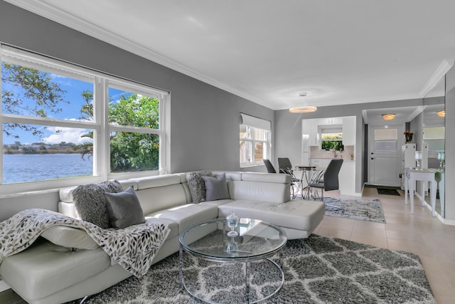 living room featuring light tile patterned floors, ornamental molding, a water view, and baseboards