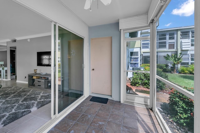 unfurnished sunroom with a ceiling fan, a healthy amount of sunlight, and visible vents