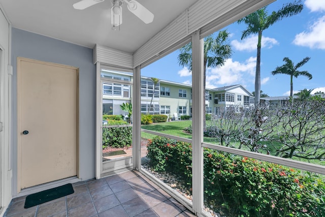 unfurnished sunroom with ceiling fan