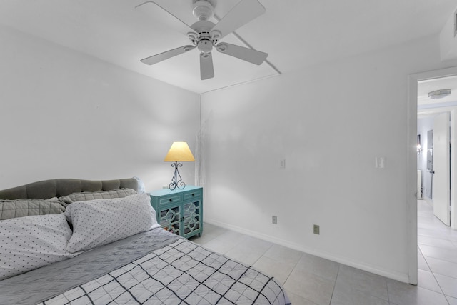 bedroom featuring a ceiling fan, light tile patterned flooring, and baseboards