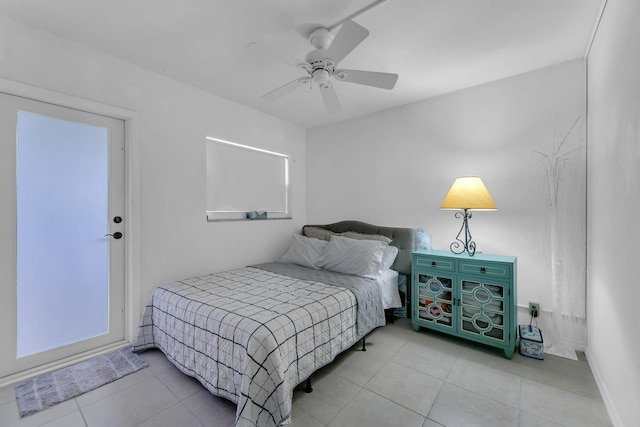 tiled bedroom with a ceiling fan