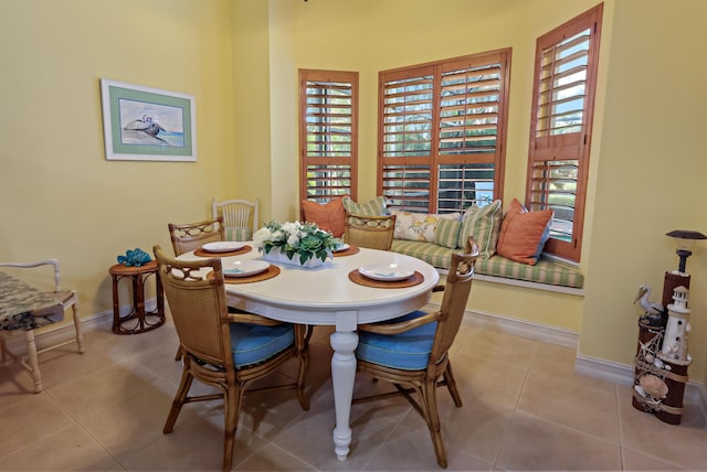 dining space featuring tile patterned flooring and baseboards