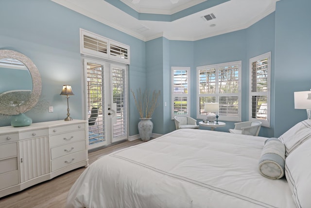 bedroom featuring visible vents, access to exterior, ornamental molding, french doors, and light wood finished floors