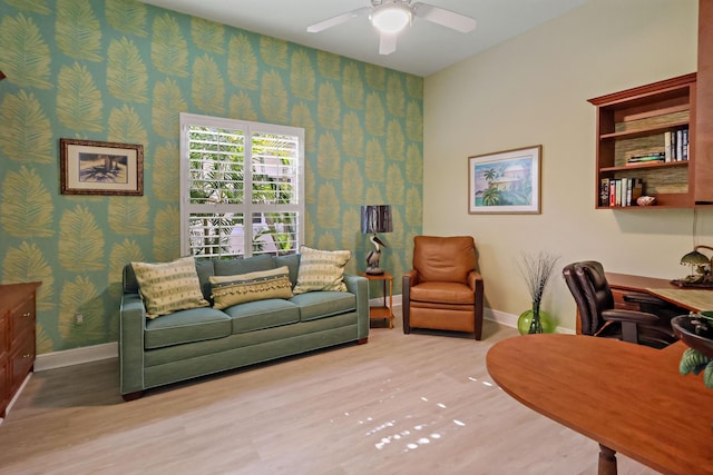 home office featuring baseboards, wood finished floors, a ceiling fan, and wallpapered walls