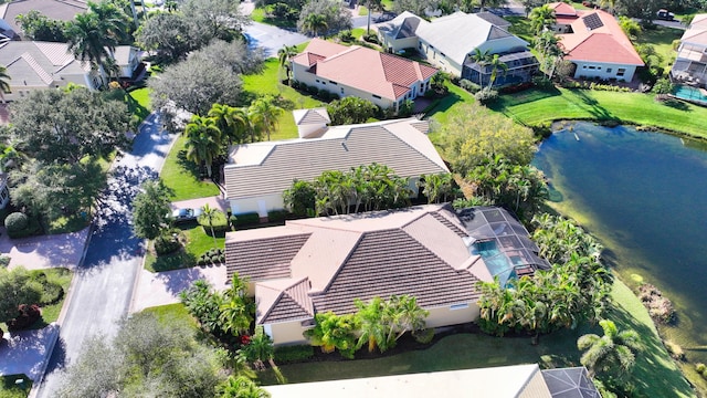 drone / aerial view featuring a water view and a residential view