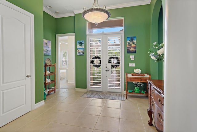 entryway with ornamental molding, french doors, light tile patterned floors, and baseboards