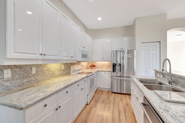 7314 Toscane Ct, Boynton Beach, FL 33437 - kitchen featuring appliances with stainless steel finishes, a sink, white cabinetry, light stone countertops, and recessed lighting