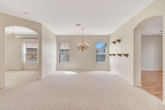 7314 Toscane Ct, Boynton Beach, FL 33437 - empty room with healthy amount of natural light, a ceiling fan, arched walkways, and carpet flooring