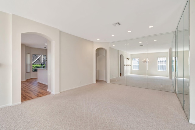 7314 Toscane Ct, Boynton Beach, FL 33437 - unfurnished bedroom with light carpet, arched walkways, a chandelier, baseboards, and recessed lighting