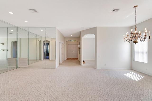 7314 Toscane Ct, Boynton Beach, FL 33437 - spare room featuring arched walkways, light colored carpet, baseboards, a chandelier, and recessed lighting