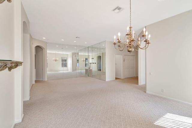 7314 Toscane Ct, Boynton Beach, FL 33437 - unfurnished room featuring a chandelier, light carpet, arched walkways, baseboards, and recessed lighting