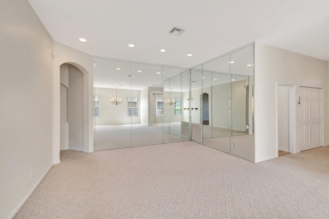 7314 Toscane Ct, Boynton Beach, FL 33437 - unfurnished room featuring arched walkways, light colored carpet, a chandelier, baseboards, and recessed lighting