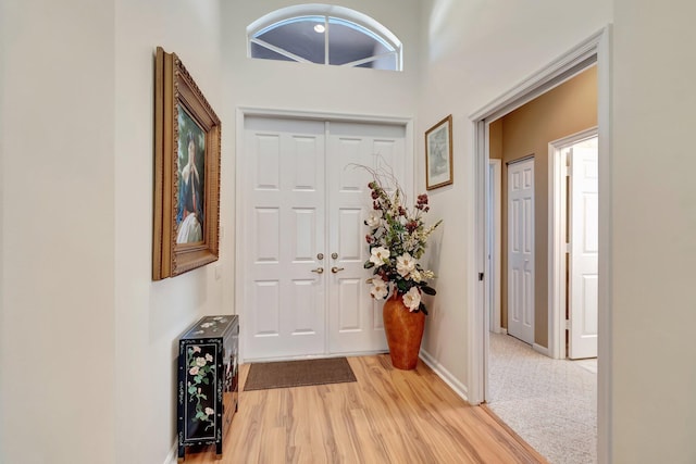 entryway with light wood-style flooring and baseboards