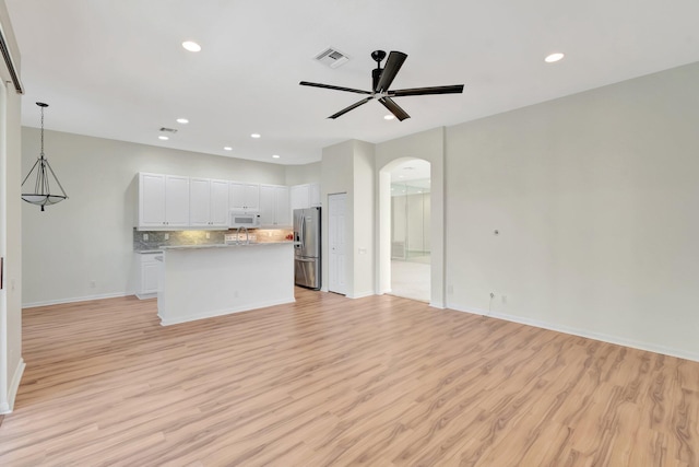 7314 Toscane Ct, Boynton Beach, FL 33437 - kitchen featuring white microwave, open floor plan, stainless steel fridge, arched walkways, and ceiling fan