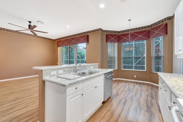 kitchen featuring a sink, stainless steel dishwasher, light wood finished floors, baseboards, and recessed lighting