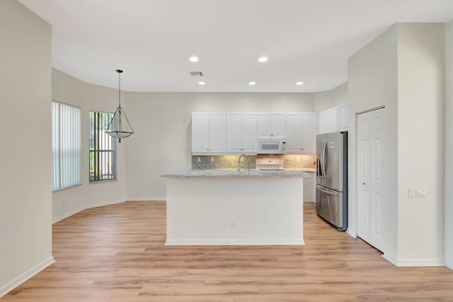 7314 Toscane Ct, Boynton Beach, FL 33437 - kitchen featuring white appliances, light wood-type flooring, white cabinetry, decorative backsplash, and a sink