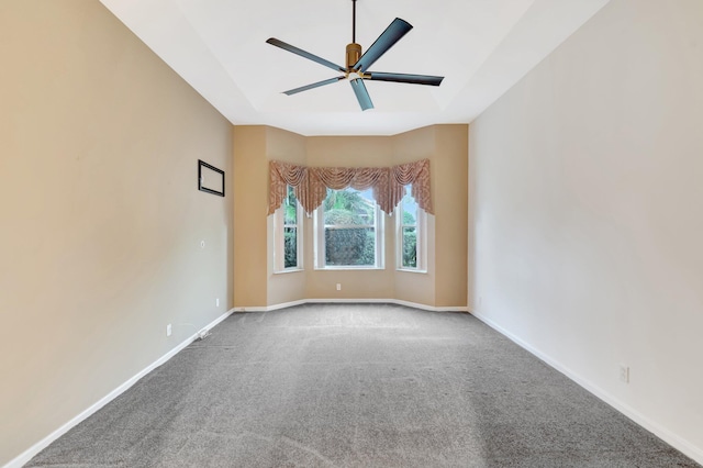 empty room featuring a ceiling fan, carpet, and baseboards