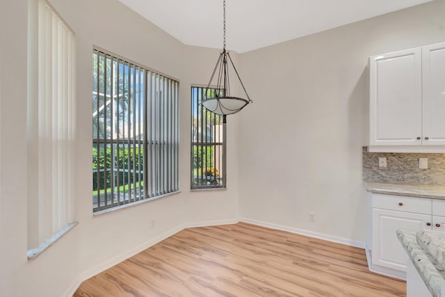 7314 Toscane Ct, Boynton Beach, FL 33437 - unfurnished dining area with light wood-style floors, healthy amount of natural light, and baseboards