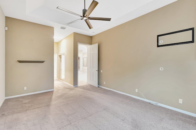 empty room with ceiling fan, carpet flooring, and baseboards