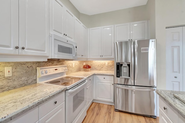 7314 Toscane Ct, Boynton Beach, FL 33437 - kitchen featuring white appliances, white cabinets, light wood-style flooring, and backsplash