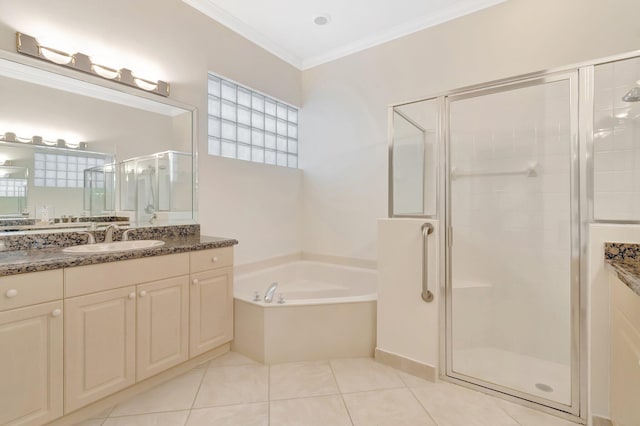 bathroom featuring a stall shower, crown molding, a garden tub, vanity, and tile patterned floors