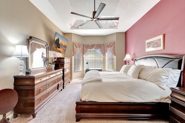 carpeted bedroom featuring ceiling fan, baseboards, and a textured ceiling