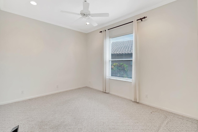 unfurnished room featuring light colored carpet, ceiling fan, and baseboards