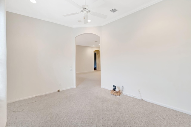 empty room with arched walkways, a ceiling fan, carpet floors, baseboards, and recessed lighting