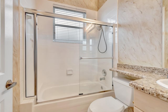 full bathroom with toilet, shower / bath combination with glass door, and vanity