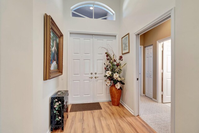 property entrance featuring a garage, a tile roof, decorative driveway, and stucco siding