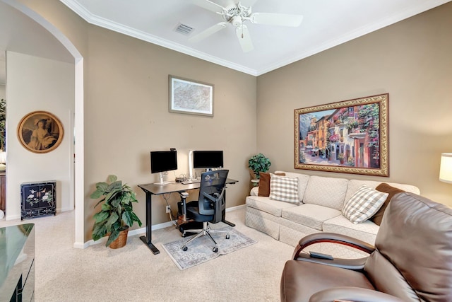 carpeted office space with baseboards, visible vents, arched walkways, ceiling fan, and crown molding