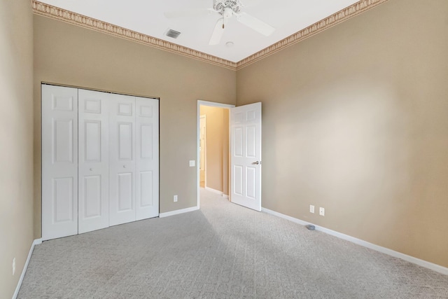 unfurnished bedroom with carpet, baseboards, a closet, and ceiling fan