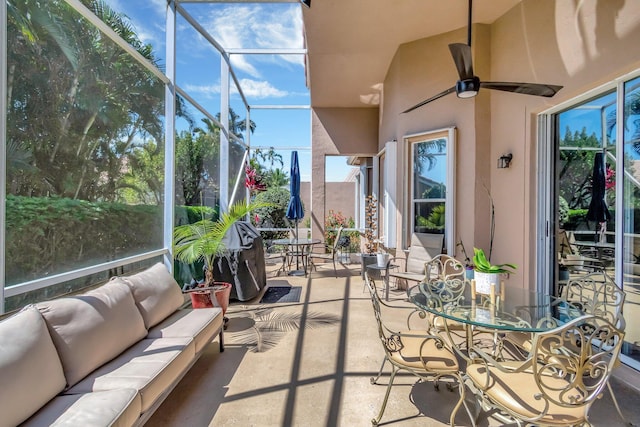sunroom / solarium featuring ceiling fan, outdoor dining area, and an outdoor living space