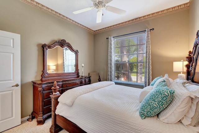 bedroom with ceiling fan, baseboards, crown molding, and light colored carpet