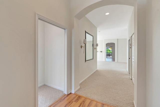 7314 Toscane Ct, Boynton Beach, FL 33437 - corridor featuring arched walkways, wood finished floors, carpet floors, and baseboards