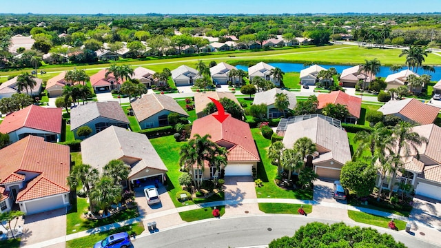 bird's eye view featuring a water view and a residential view