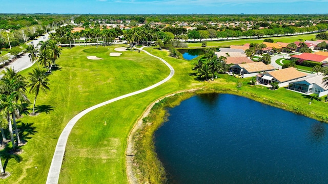 bird's eye view with a water view and view of golf course