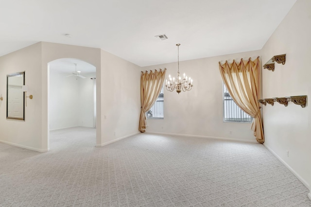 unfurnished room featuring light colored carpet, ceiling fan, a chandelier, and baseboards