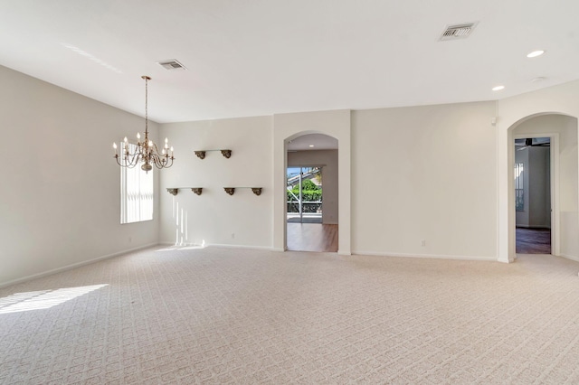 7314 Toscane Ct, Boynton Beach, FL 33437 - spare room featuring arched walkways, light carpet, baseboards, recessed lighting, and a chandelier
