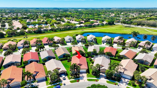 aerial perspective of suburban area with a nearby body of water and a golf club