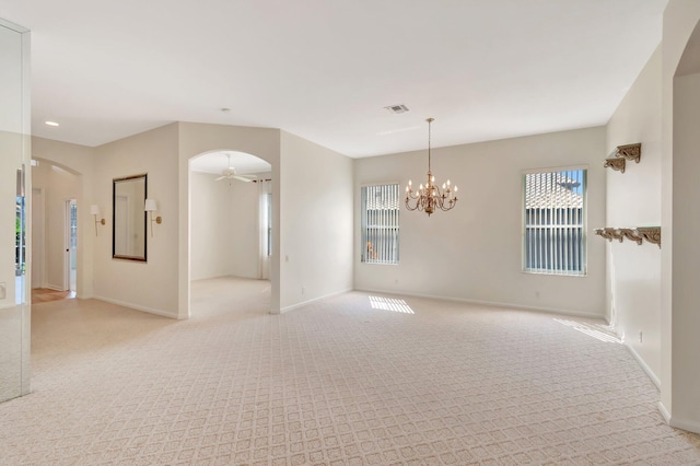 7314 Toscane Ct, Boynton Beach, FL 33437 - spare room featuring arched walkways, light carpet, baseboards, ceiling fan, and a chandelier