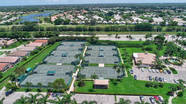 aerial view of property's location with a nearby body of water and nearby suburban area