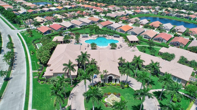 view of property location featuring a nearby body of water, nearby suburban area, and a pool